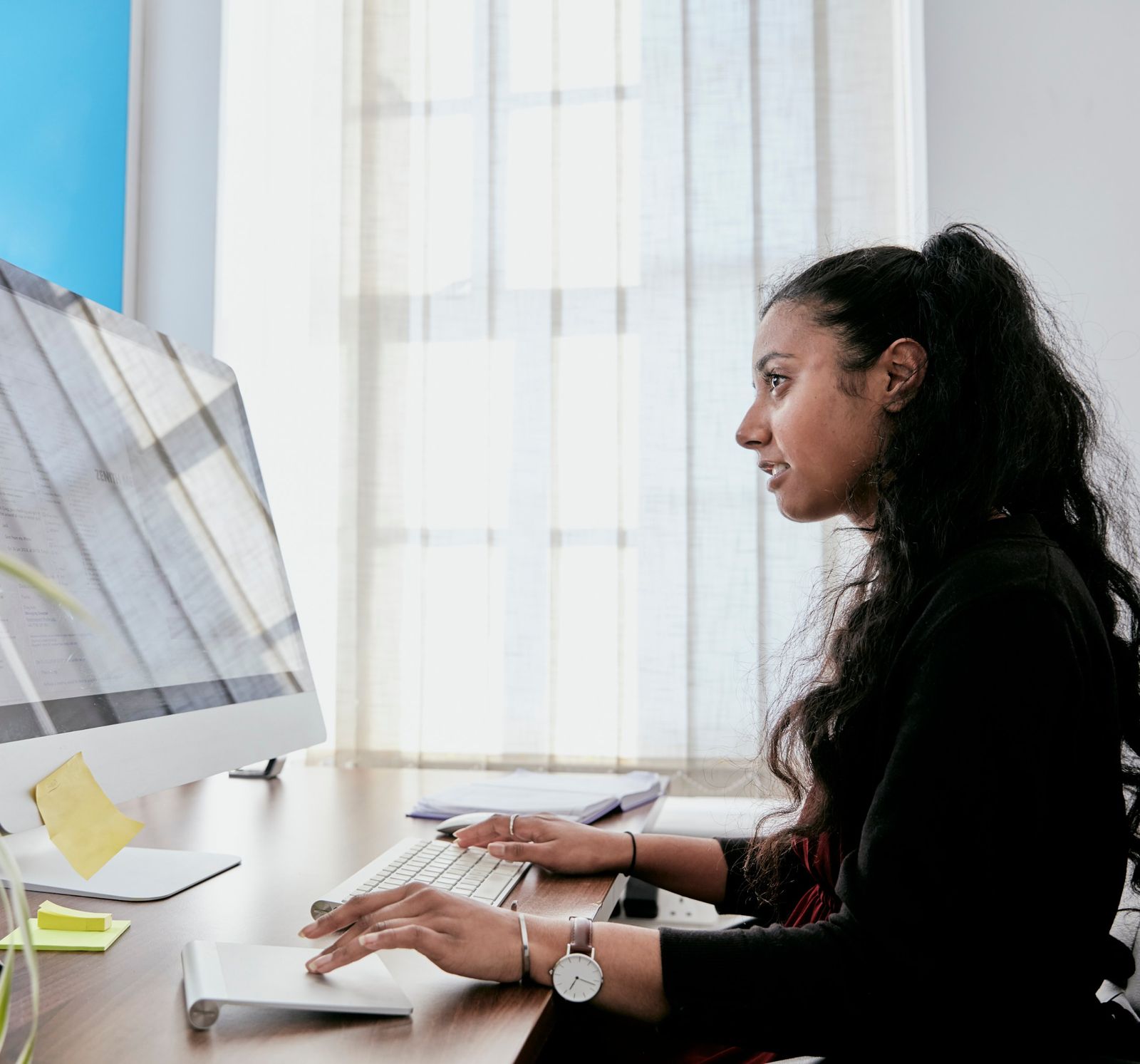 Web designer building a conversion-focused website at her desk